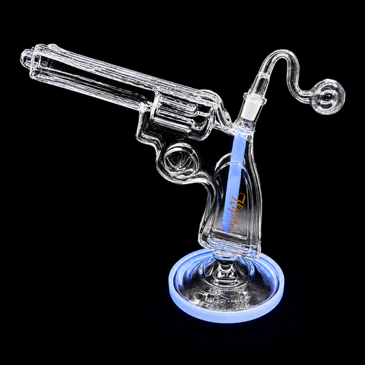 Glass smoking device shaped like a revolver on a black background