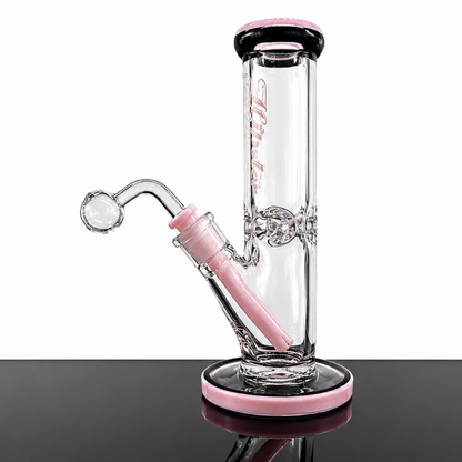 A clear glass water pipe with pink accents, featuring a cylindrical chamber, curved banger, and pink base, displayed on a reflective black surface against a white background.