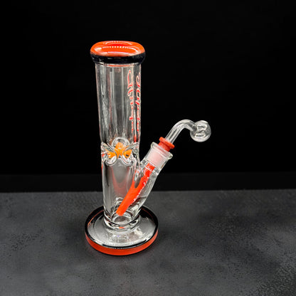 Glass water pipe with red accents on a black background