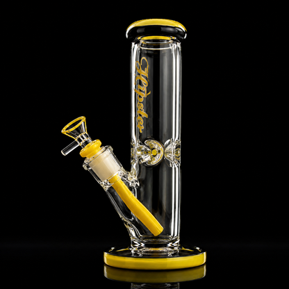 A clear glass water pipe with bright yellow accents, a black mouthpiece, and gold script branding on the main tube, set against a solid black background.