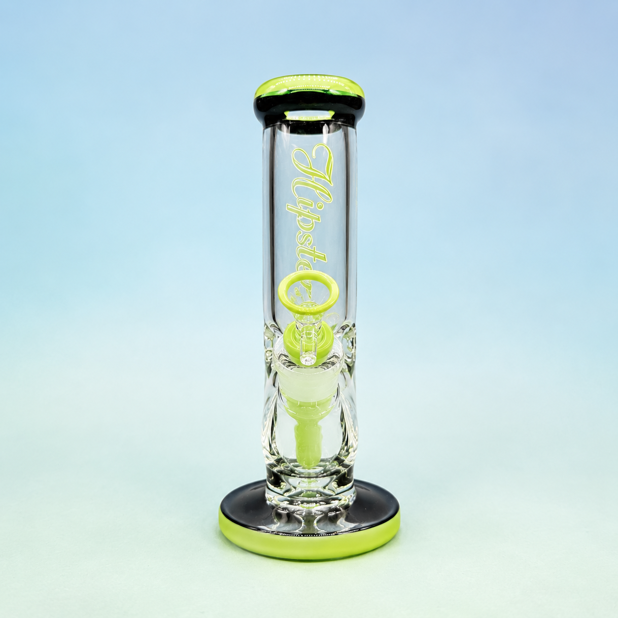 Glass water pipe with green accents on a light blue background