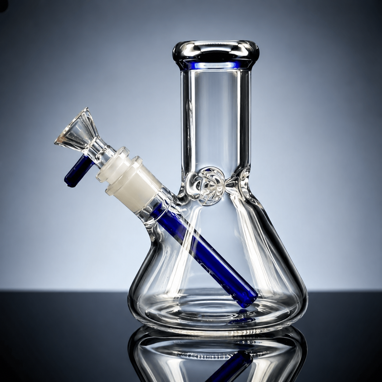 Clear glass water pipe with blue accents on a reflective surface
