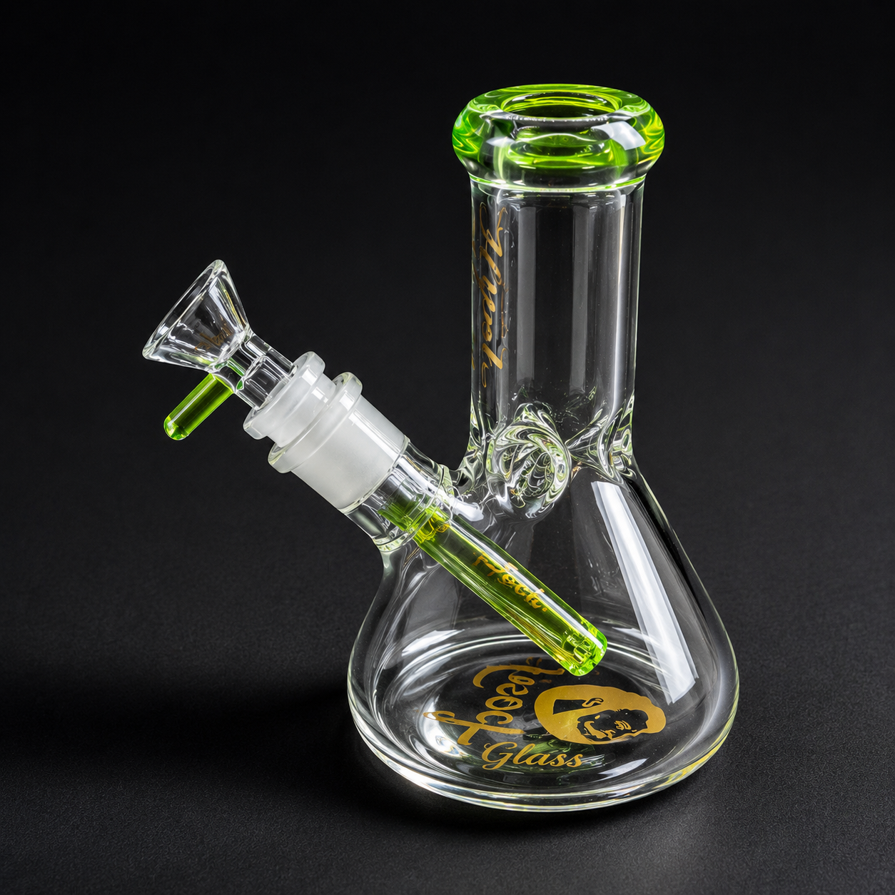 Glass smoking device with green accents on a black background