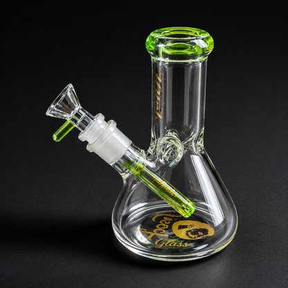 Glass smoking device with green accents on a black background