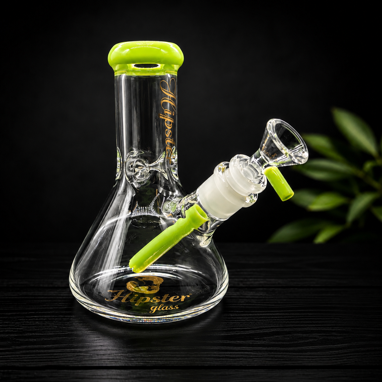 Glass smoking device with green accents on a dark background