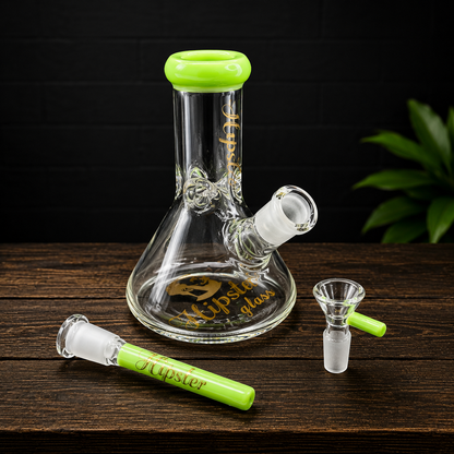 Glass smoking device with green accents on a wooden surface