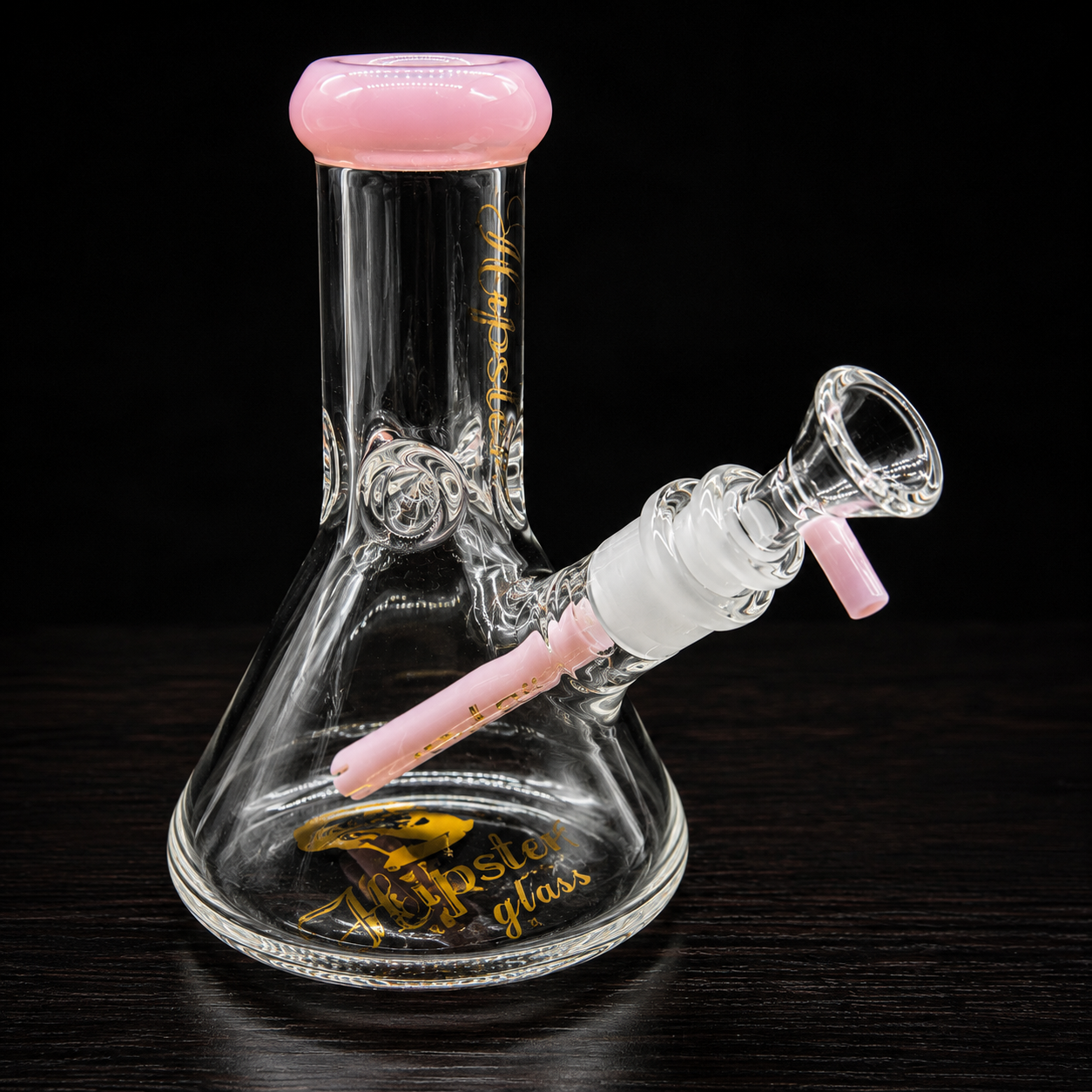 Glass smoking device with pink accents on a black background