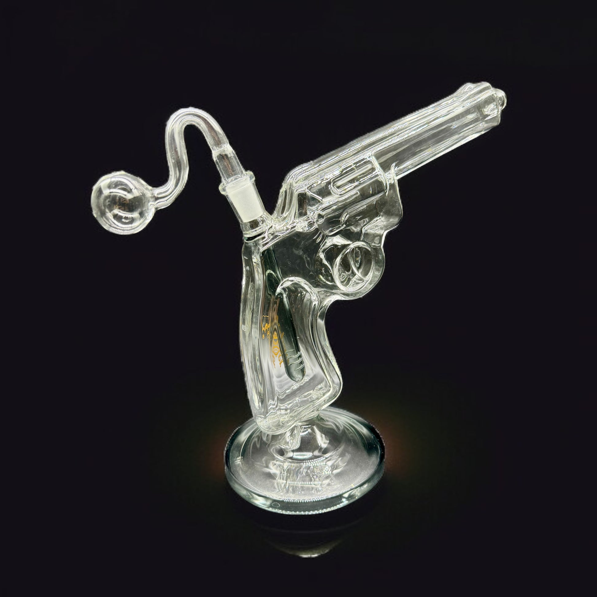Clear glass smoking accessory shaped like a revolver on a black background