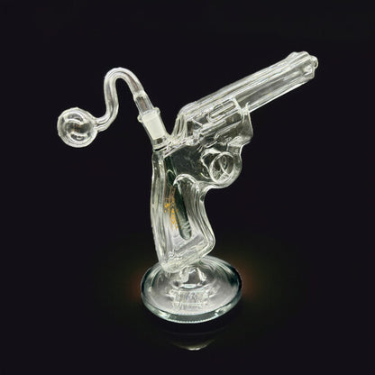 Clear glass smoking accessory shaped like a revolver on a black background