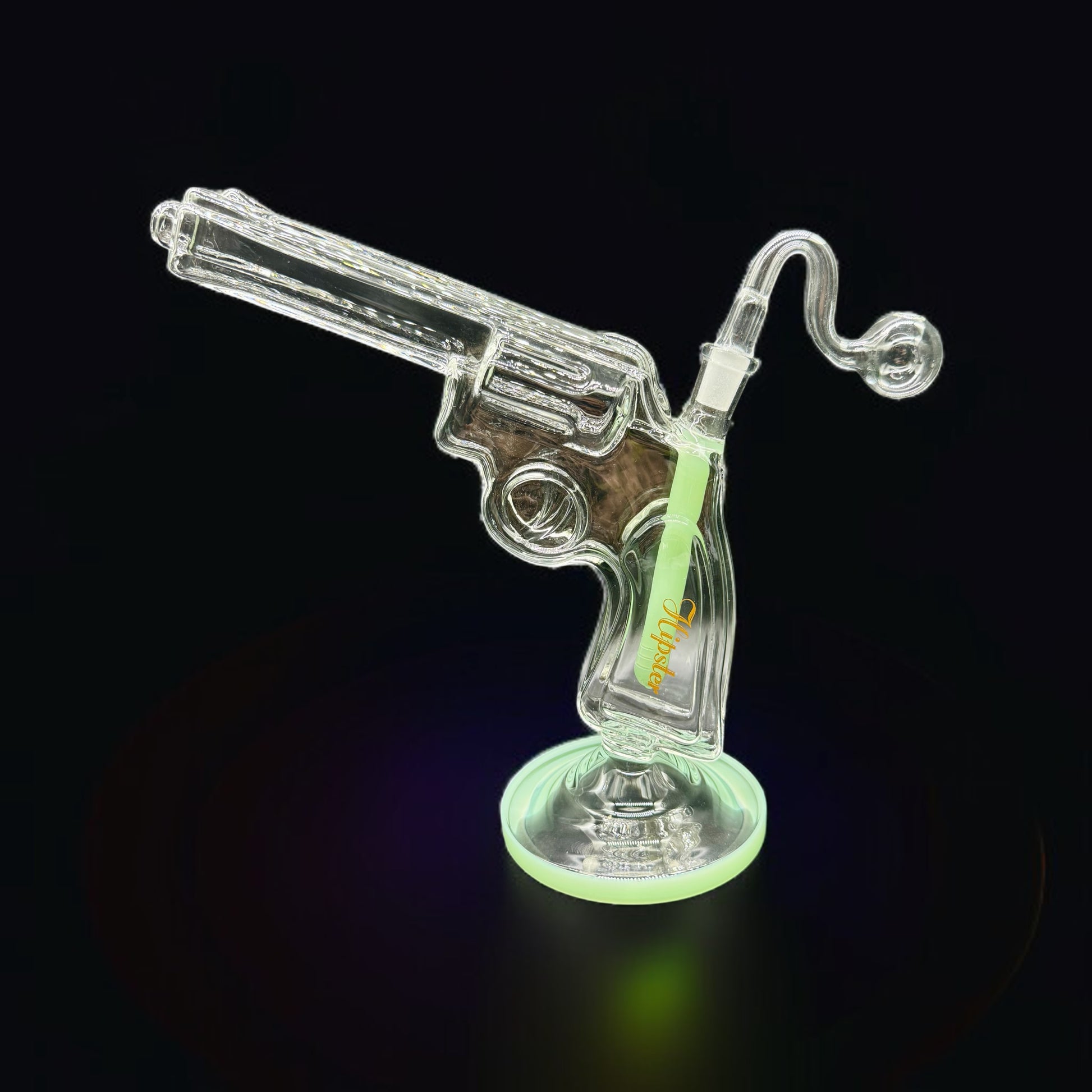 Glass smoking device shaped like a revolver on a black background