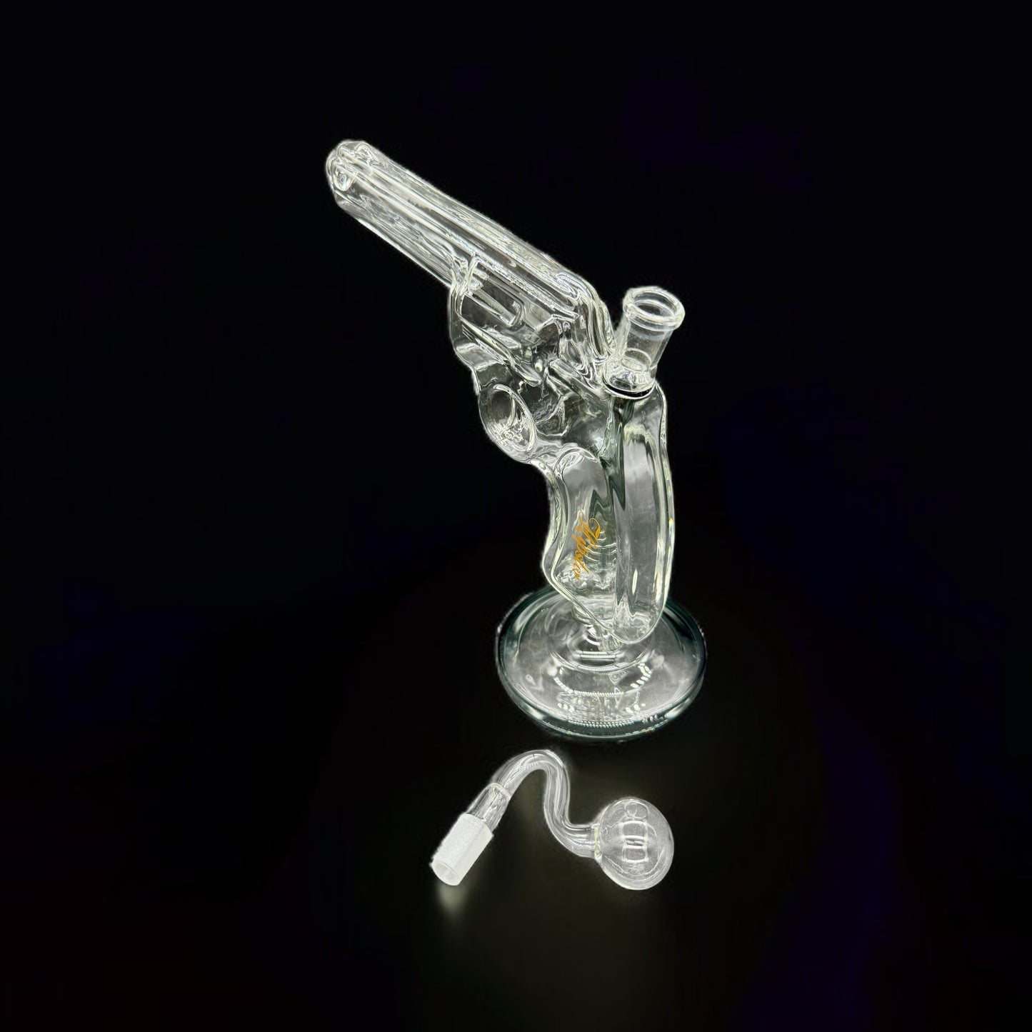 Clear glass gun-shaped water pipe on a black background