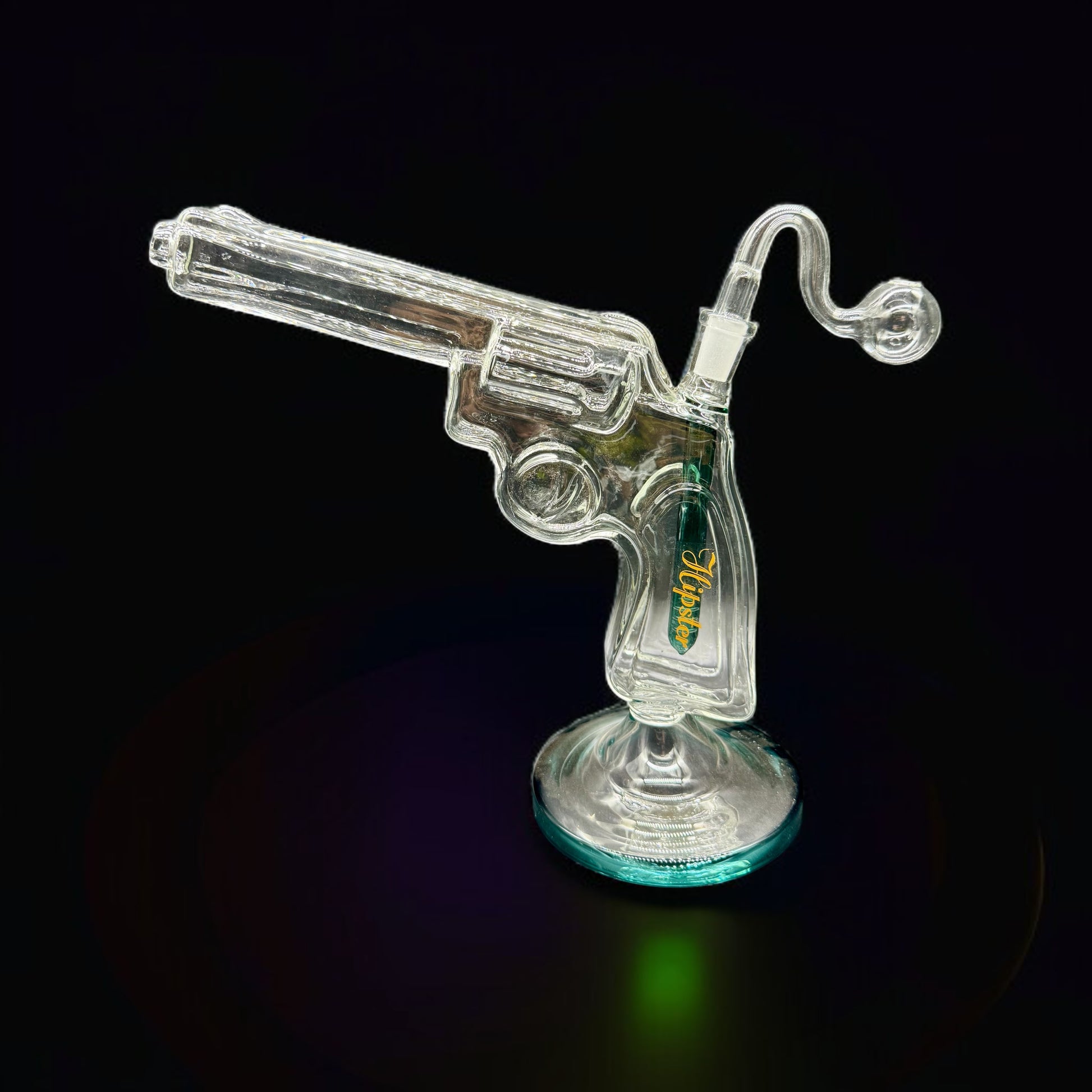 Clear glass revolver-shaped object on a black background