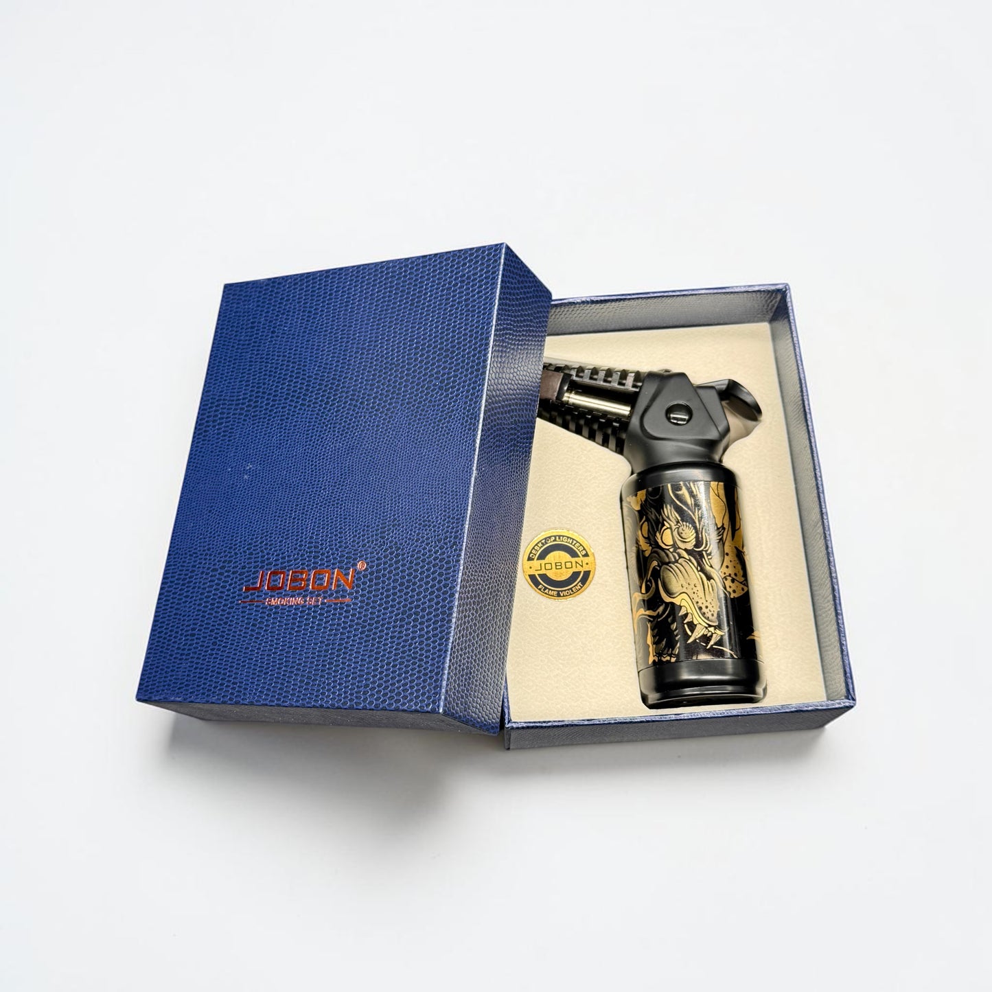 Decorative gun in a blue box with 'Jubon' branding on a white background