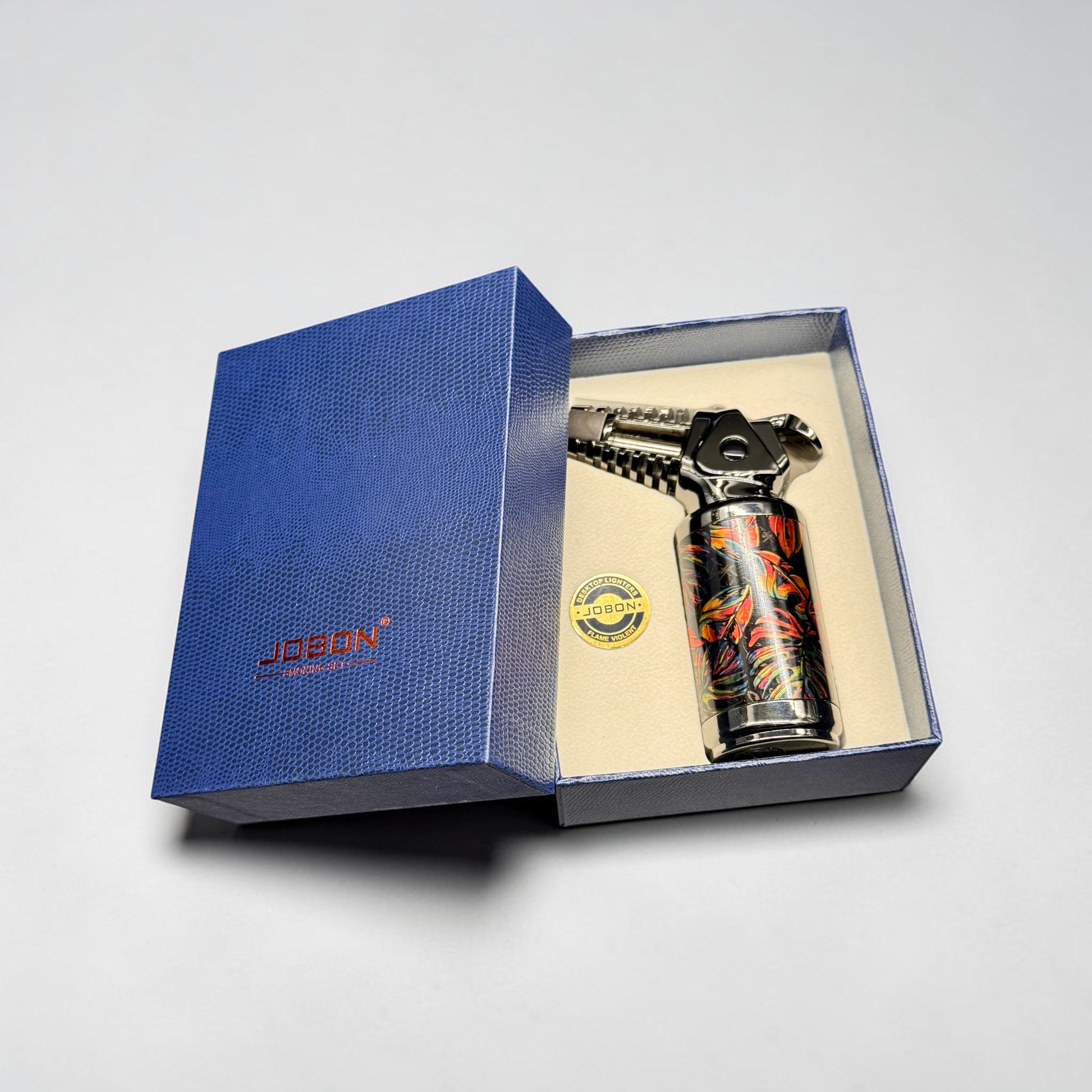 Blue gift box with a colorful spray can inside on a light gray background