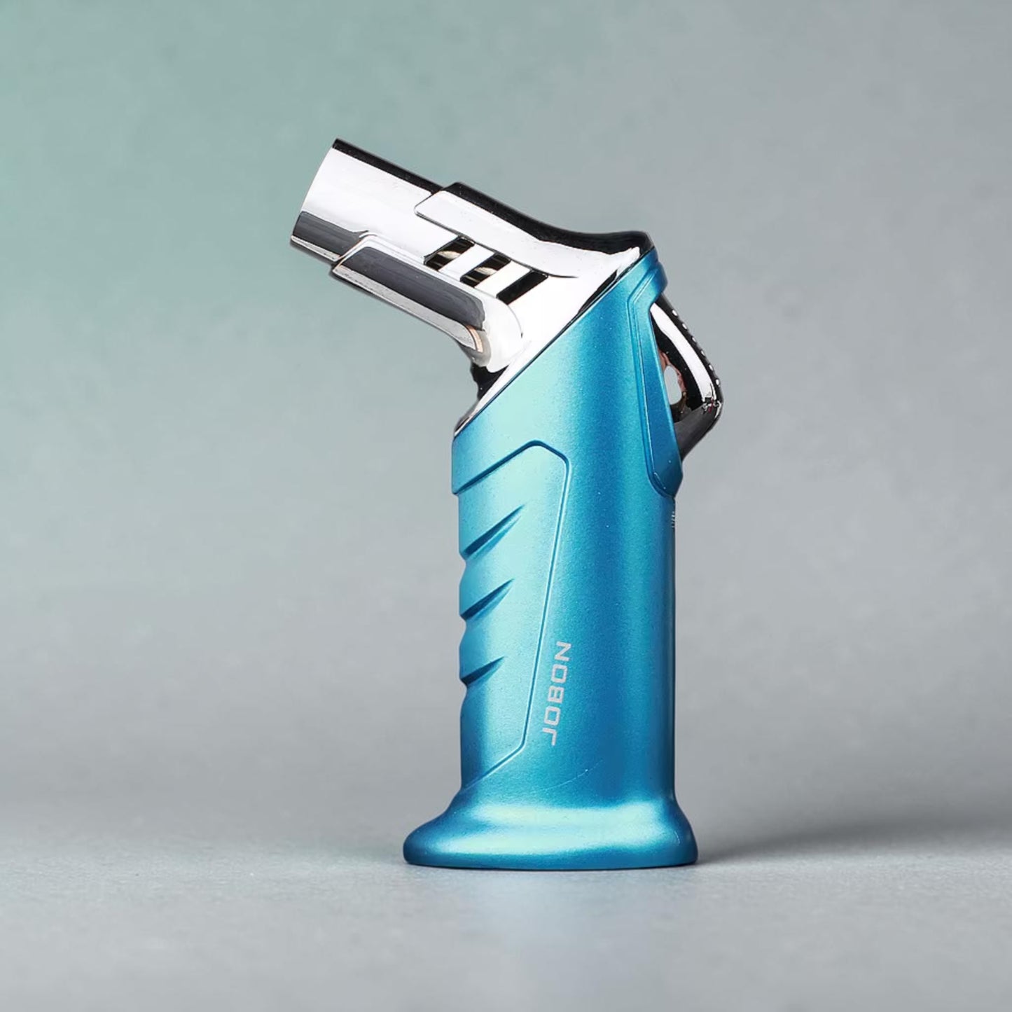 Blue lighter with chrome top on a gray background