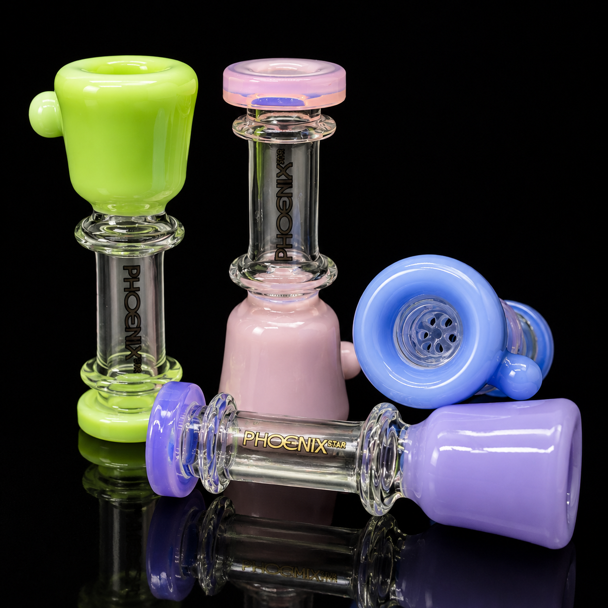 Four glass smoking accessories in green, pink, blue, and purple on a black background with 'Phoenix' branding.