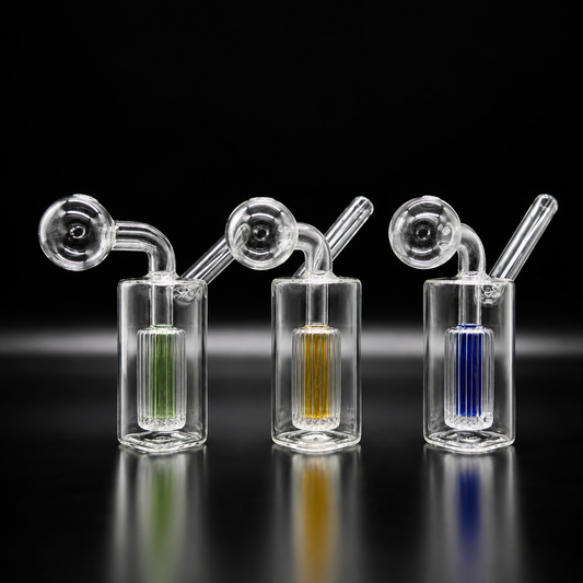Three glass smoking devices with colored liquids on a black background