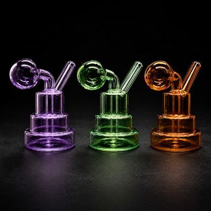 Three glass smoking devices in purple, green, and orange on a black background