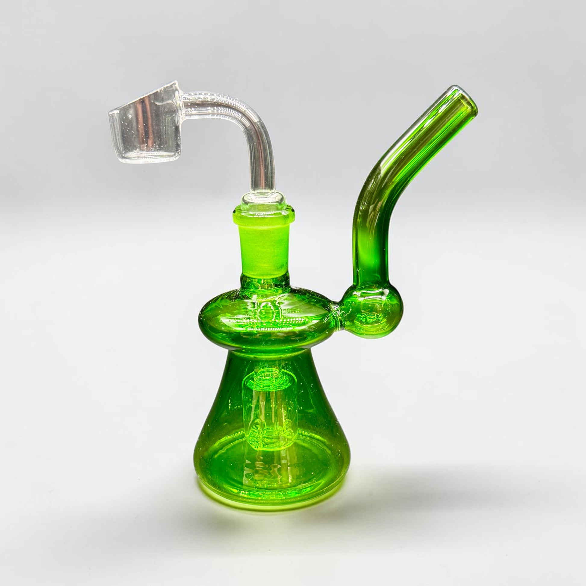 Green glass smoking device on a white background
