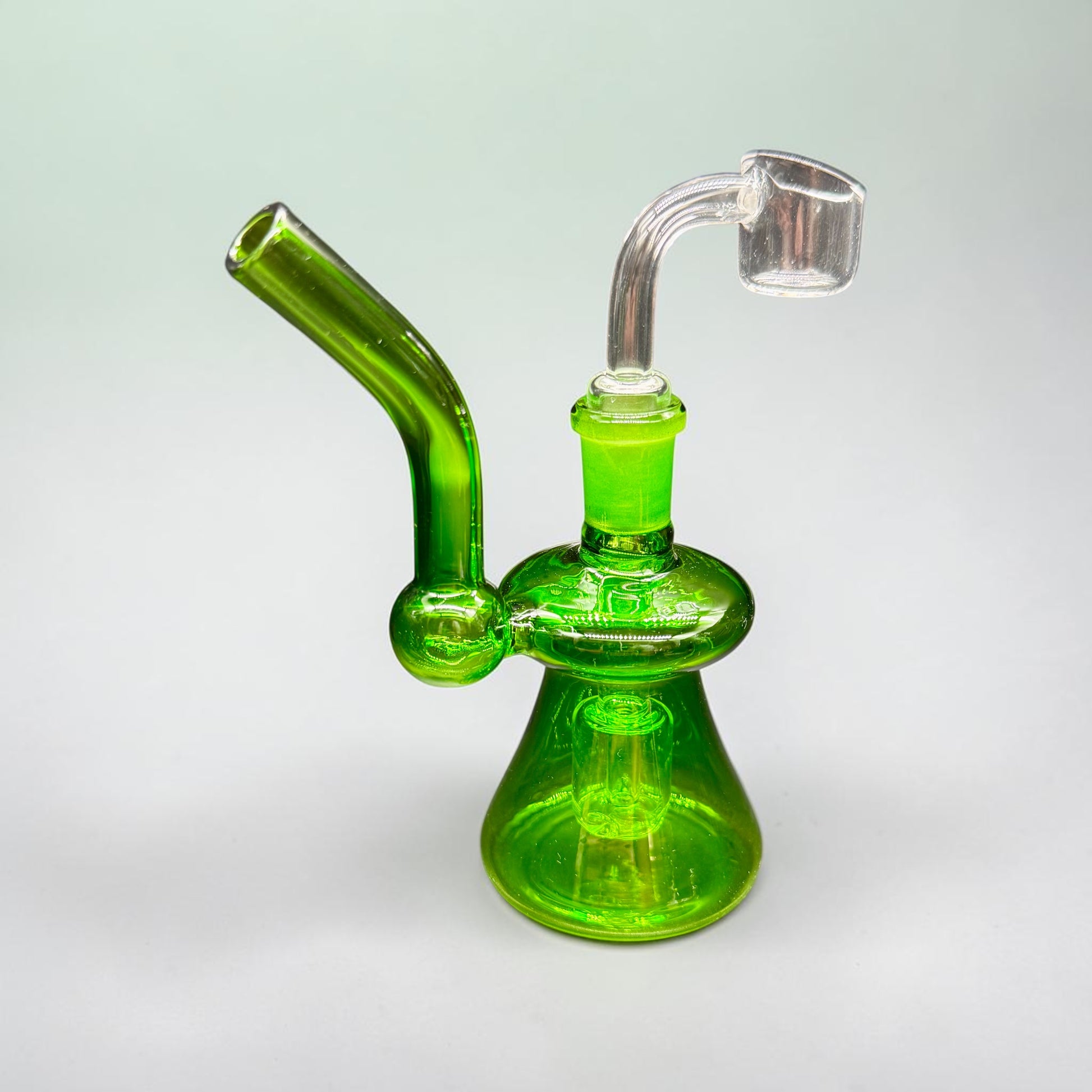 Green glass water pipe on a light gray background