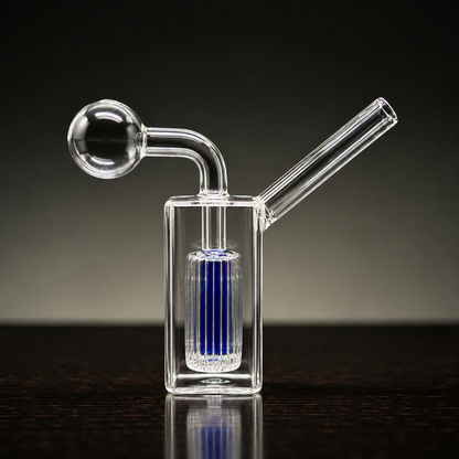 Clear glass smoking device with blue filter on a dark background