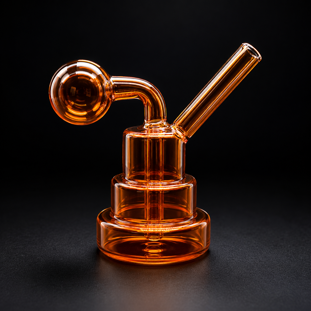 Orange glass smoking device on a black background