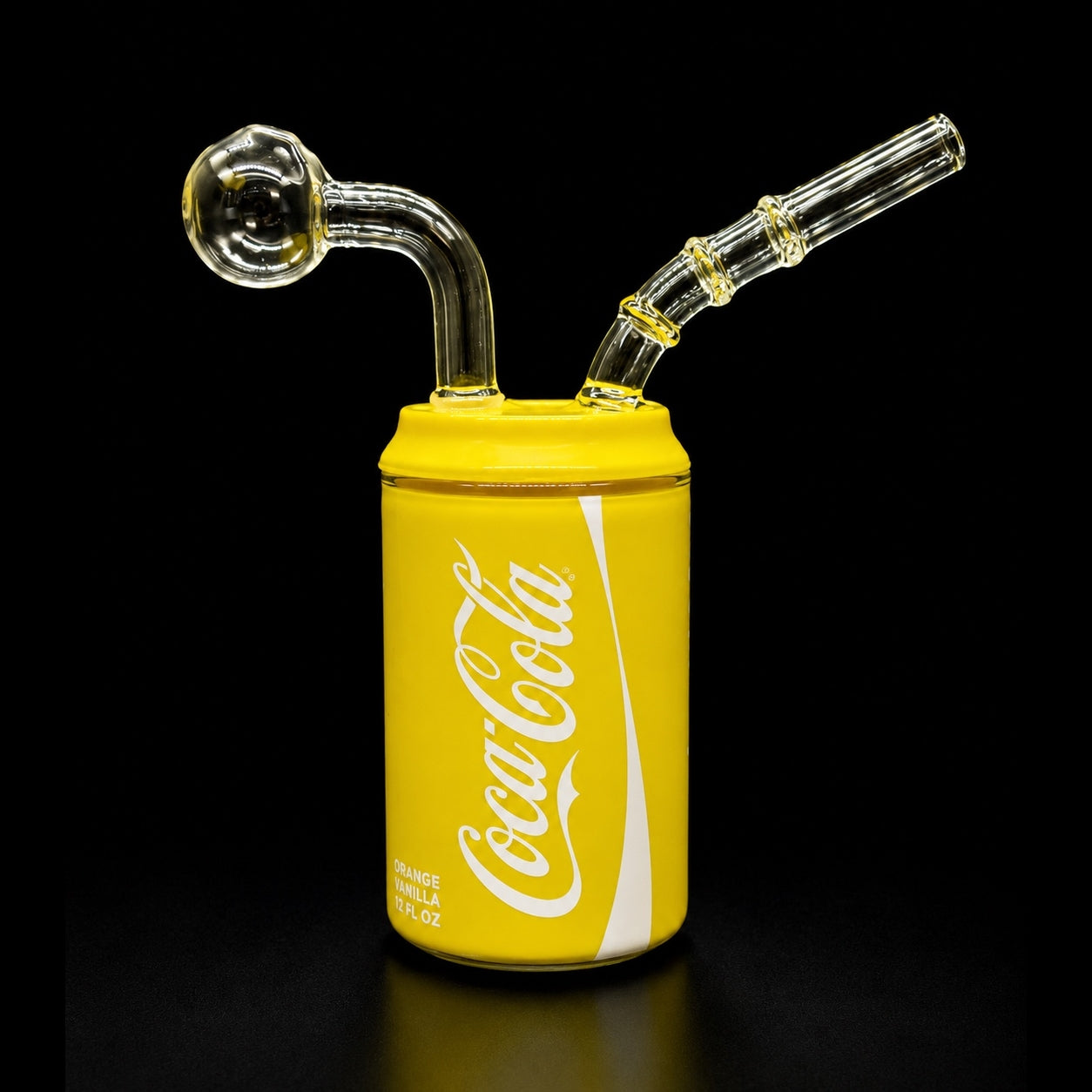 Glass smoking device shaped like a yellow Coca-Cola can on a black background