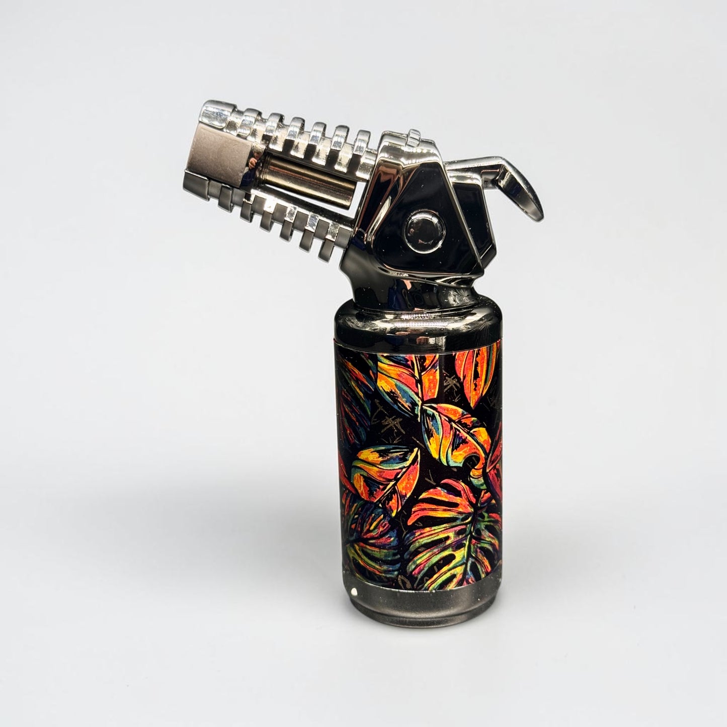 Butane lighter with colorful leaf pattern on a white background