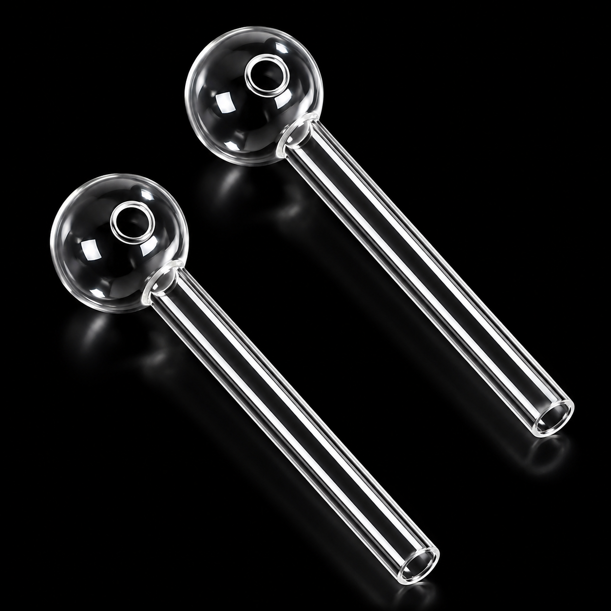 Two clear glass pipes on a black background