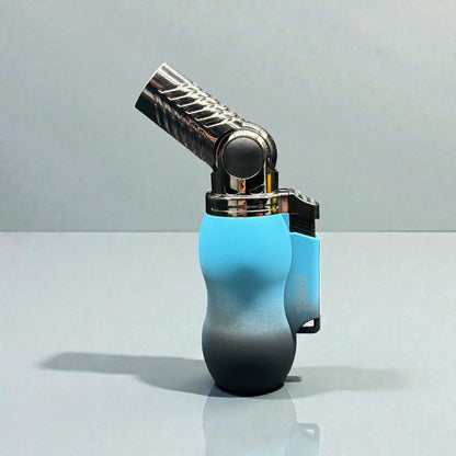 A modern lighter with a metallic silver flame tip and a body featuring a blue-to-black gradient, set against a clean gray studio background.