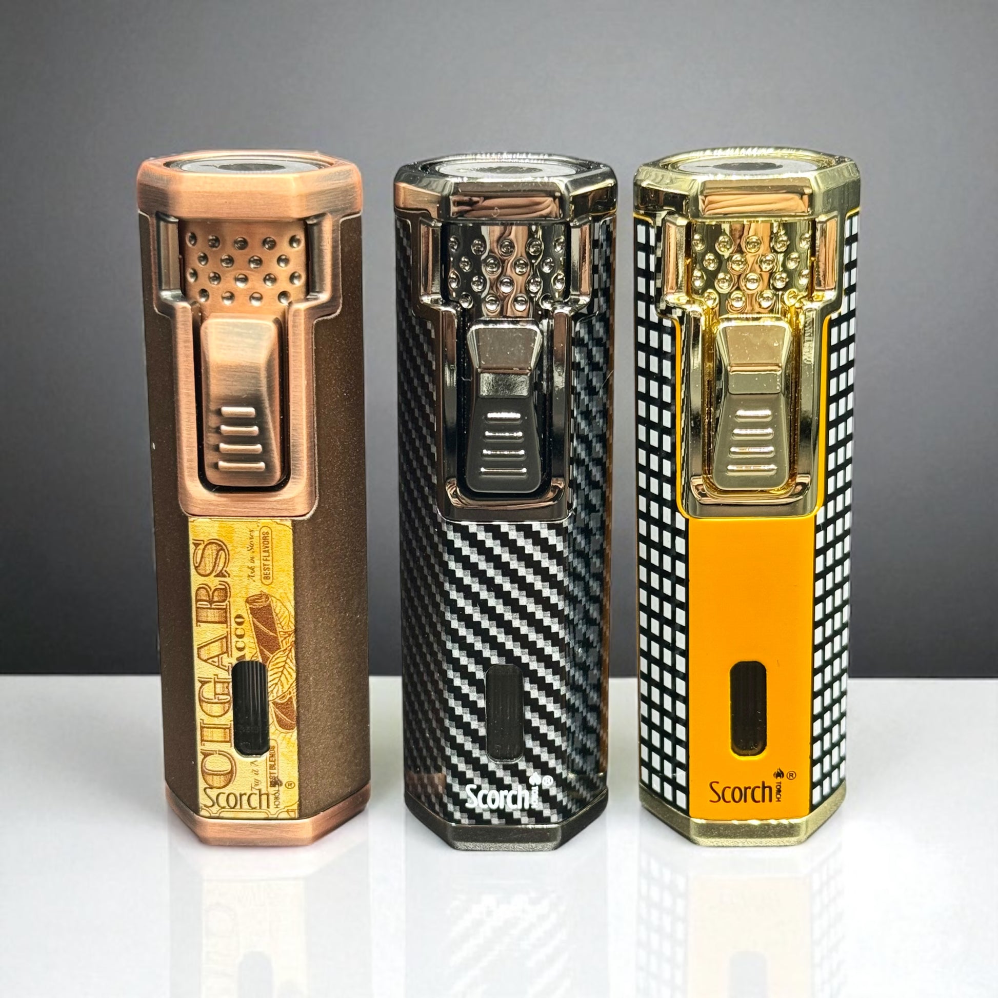 Three Scorch lighters with different designs on a gray background