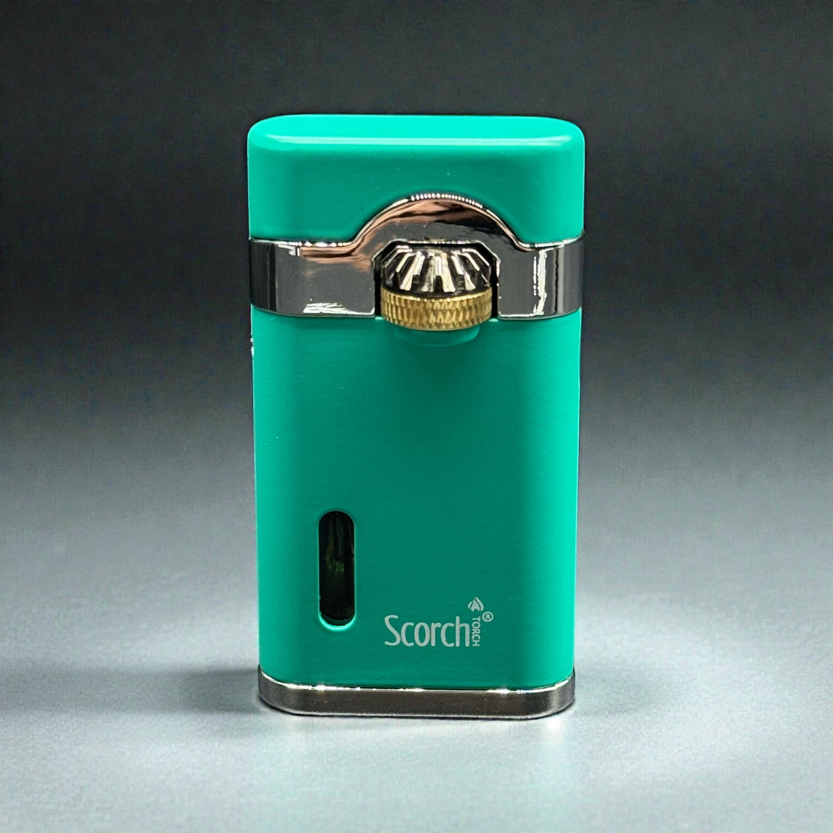 A turquoise green Scorch portable lighter with polished silver metal trim and a gold-toned ignition button, shown on a dark gray gradient background.