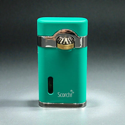 A turquoise green Scorch portable lighter with polished silver metal trim and a gold-toned ignition button, shown on a dark gray gradient background.
