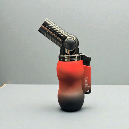 A carbon steel torch lighter with a red-to-black gradient silicone grip and a black ignition head, shown on a neutral gray background.