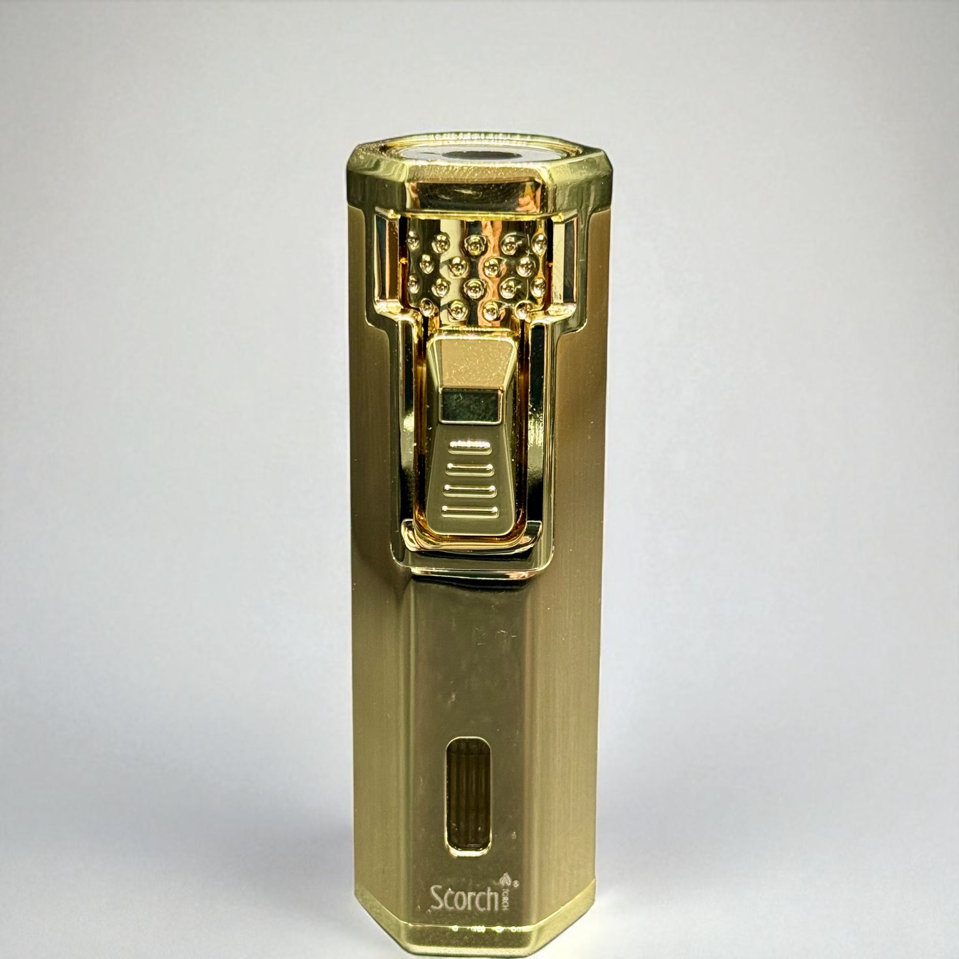 Gold lighter with 'Storch' branding on a white background