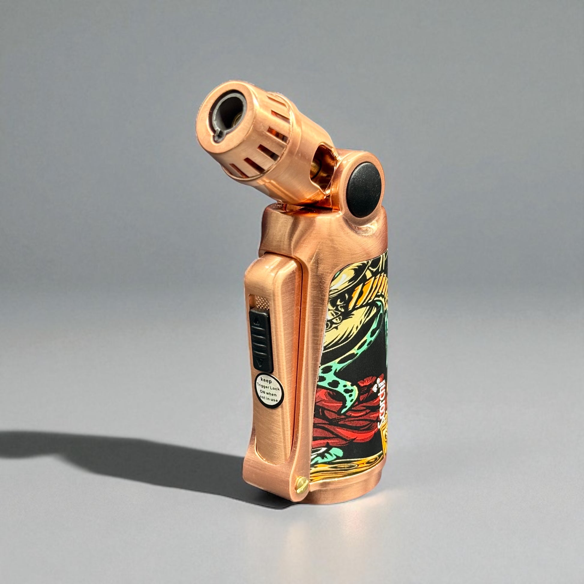 Bronze-colored lighter with colorful design on a gray background