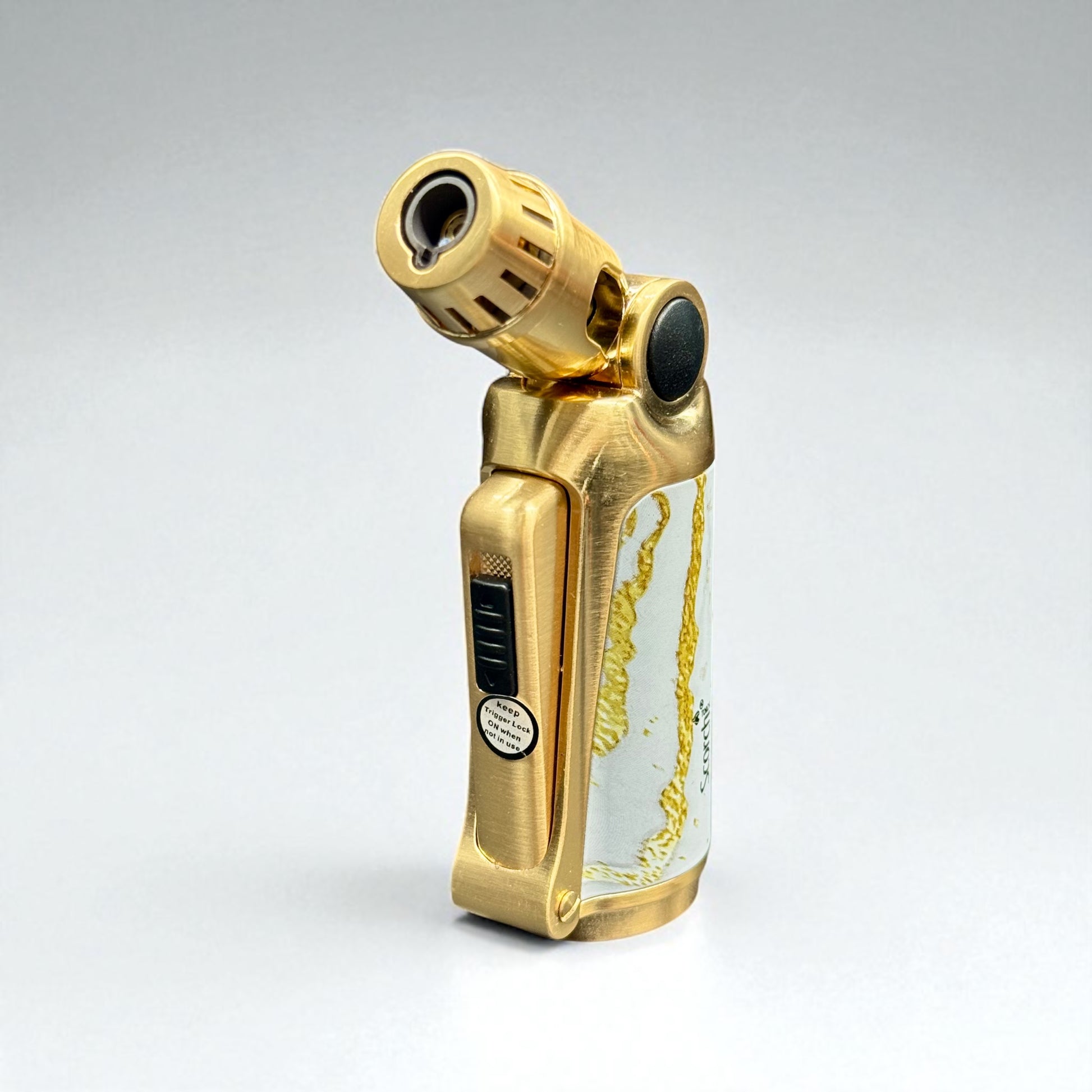 Gold lighter with a clear container on a gray background