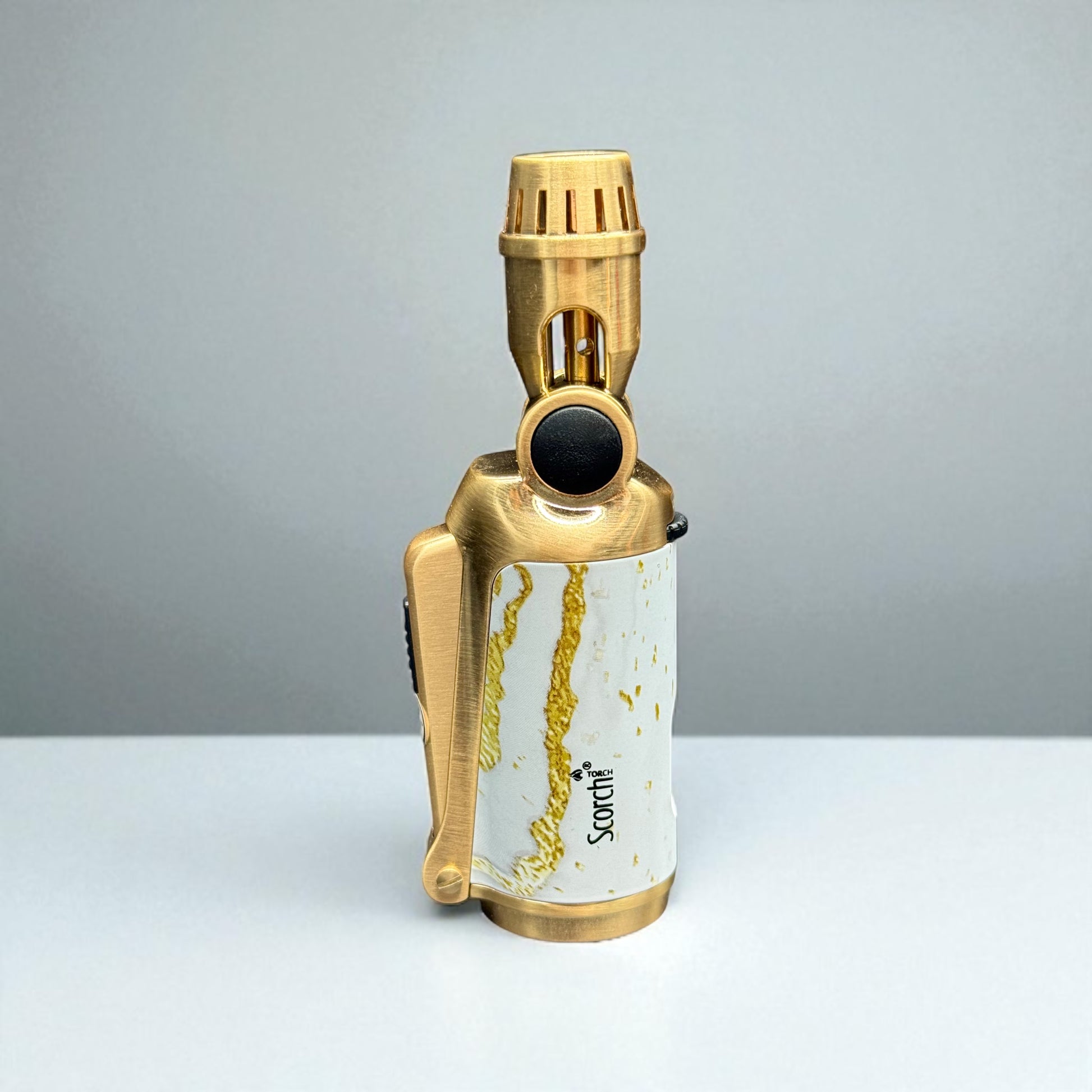 Gold and white lighter with marble design on a gray background