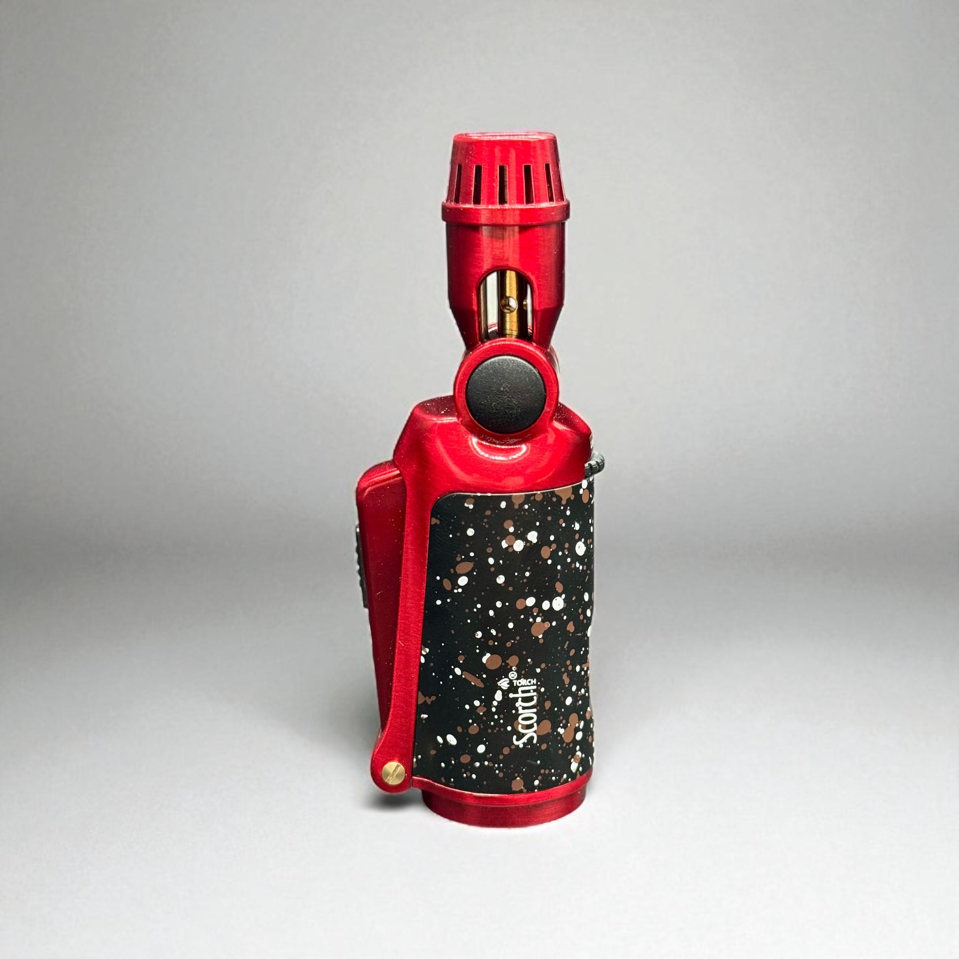Red and black speckled device on a gray background