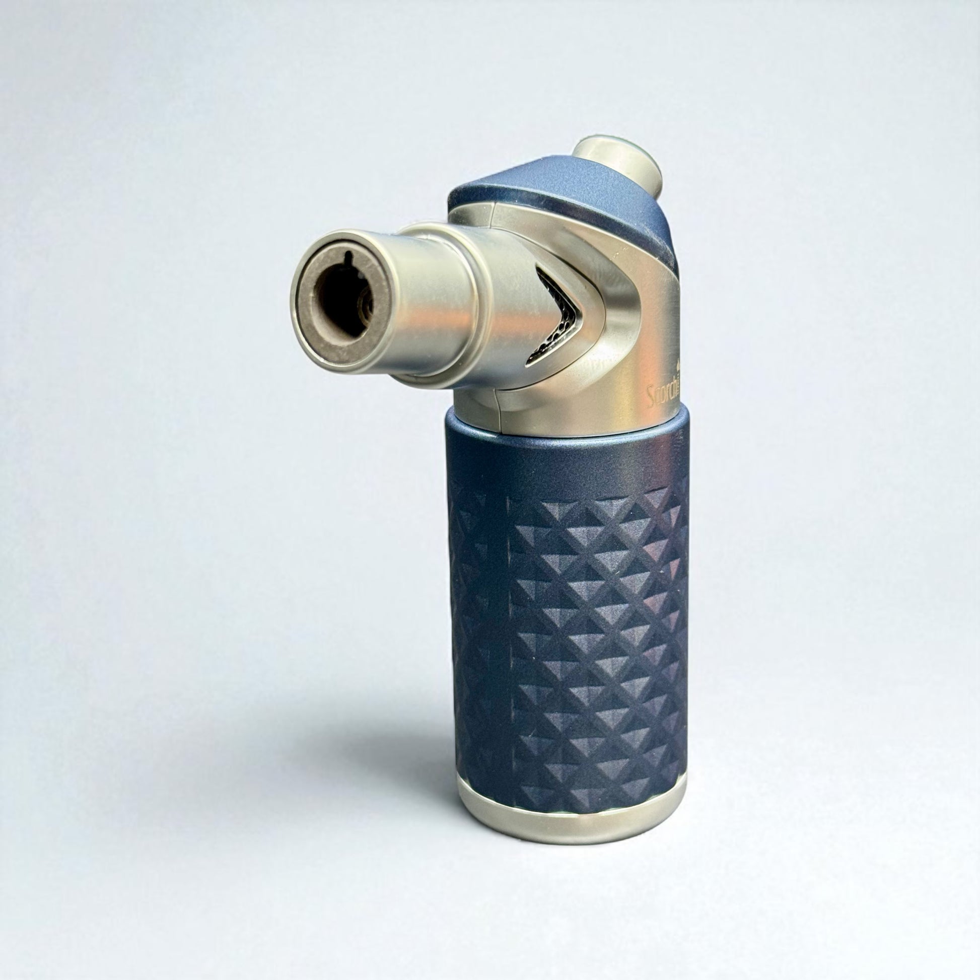 Blue and silver lighter with geometric pattern on a light gray background