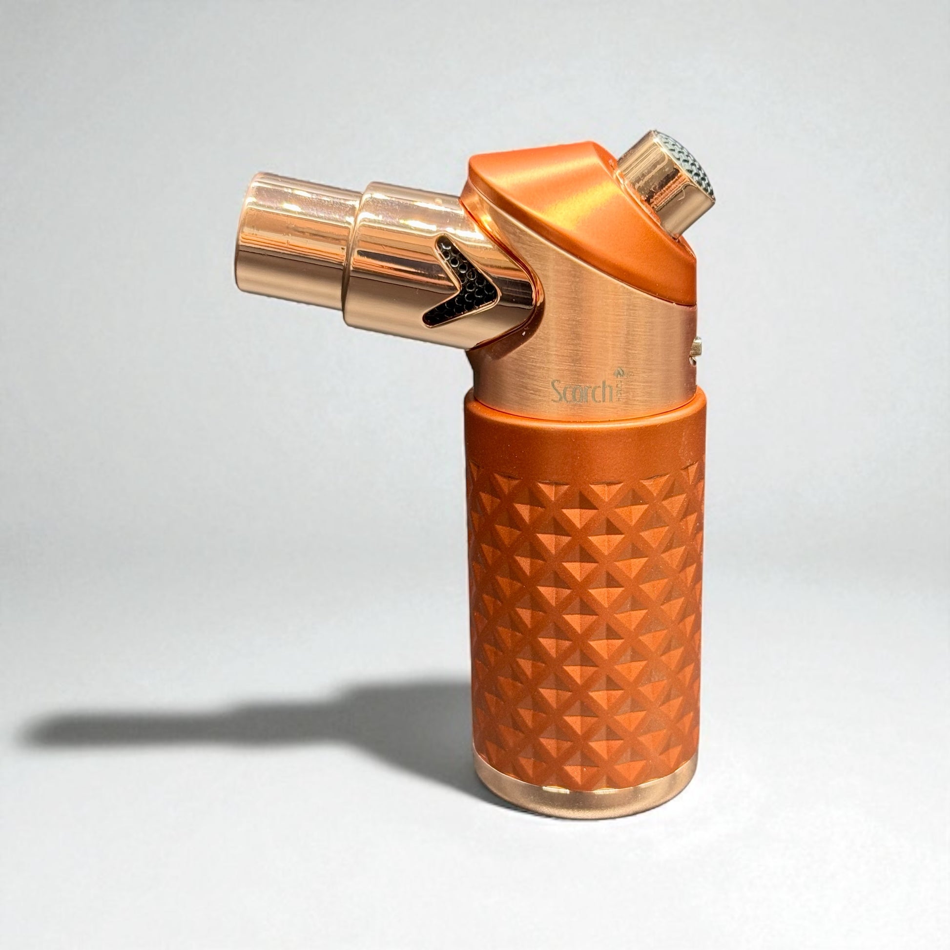 Orange and rose gold lighter with geometric pattern on a white background
