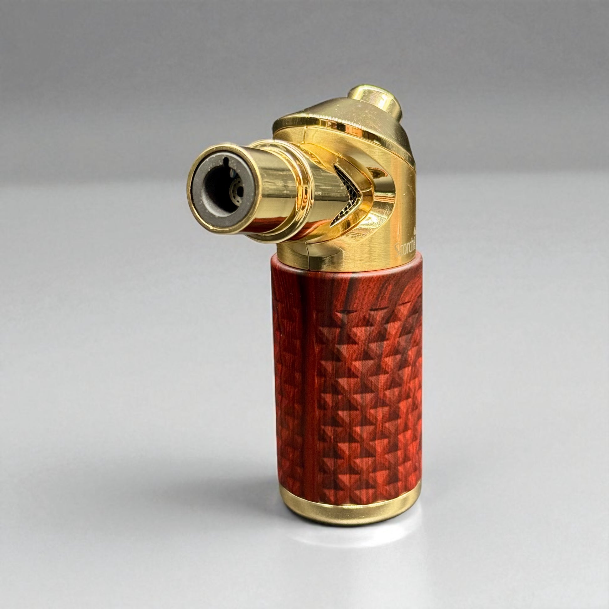 Gold and red lighter on a gray background