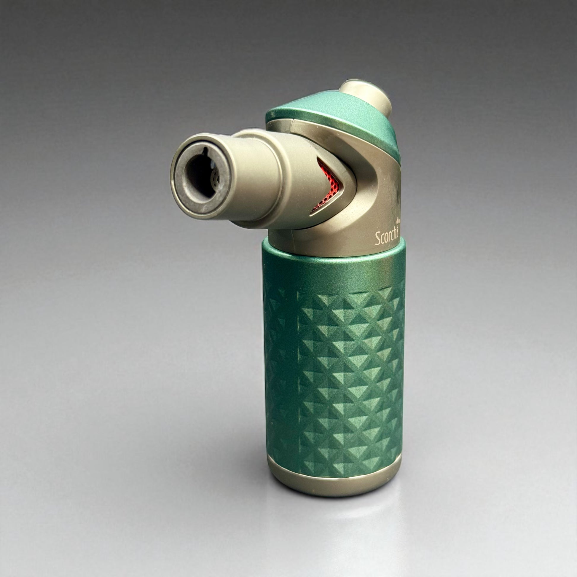 Green and silver butane lighter on a gray background