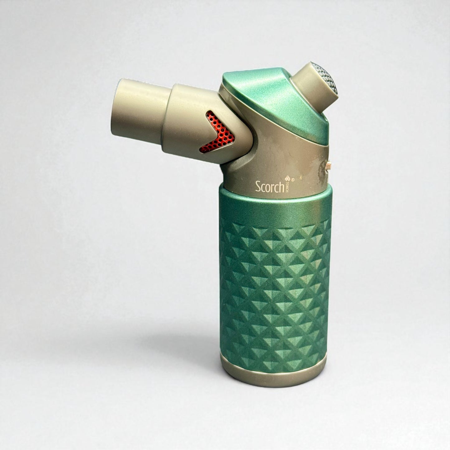 Green and gold lighter with 'Scorch' branding on a white background