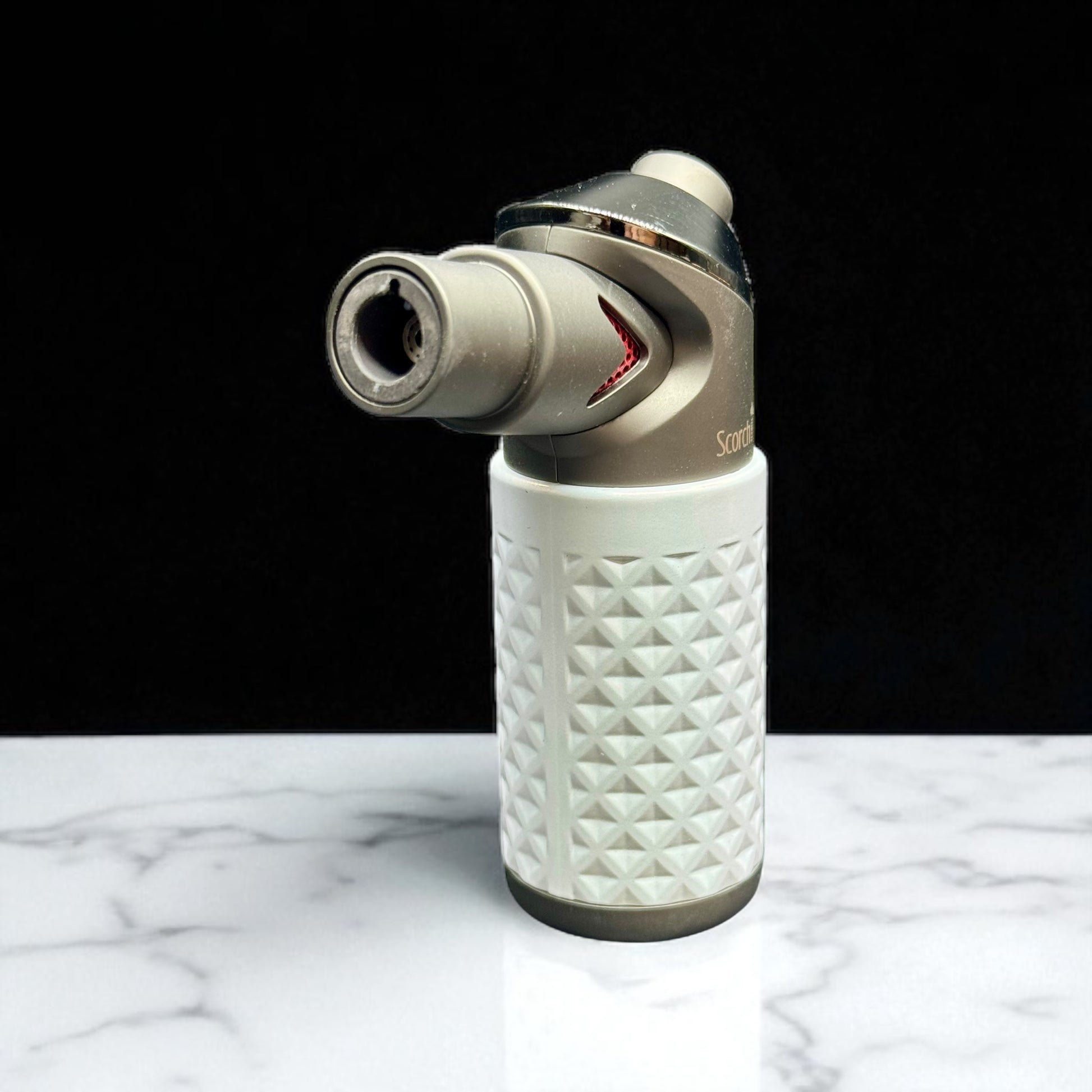White textured lighter with metallic nozzle on a marble surface