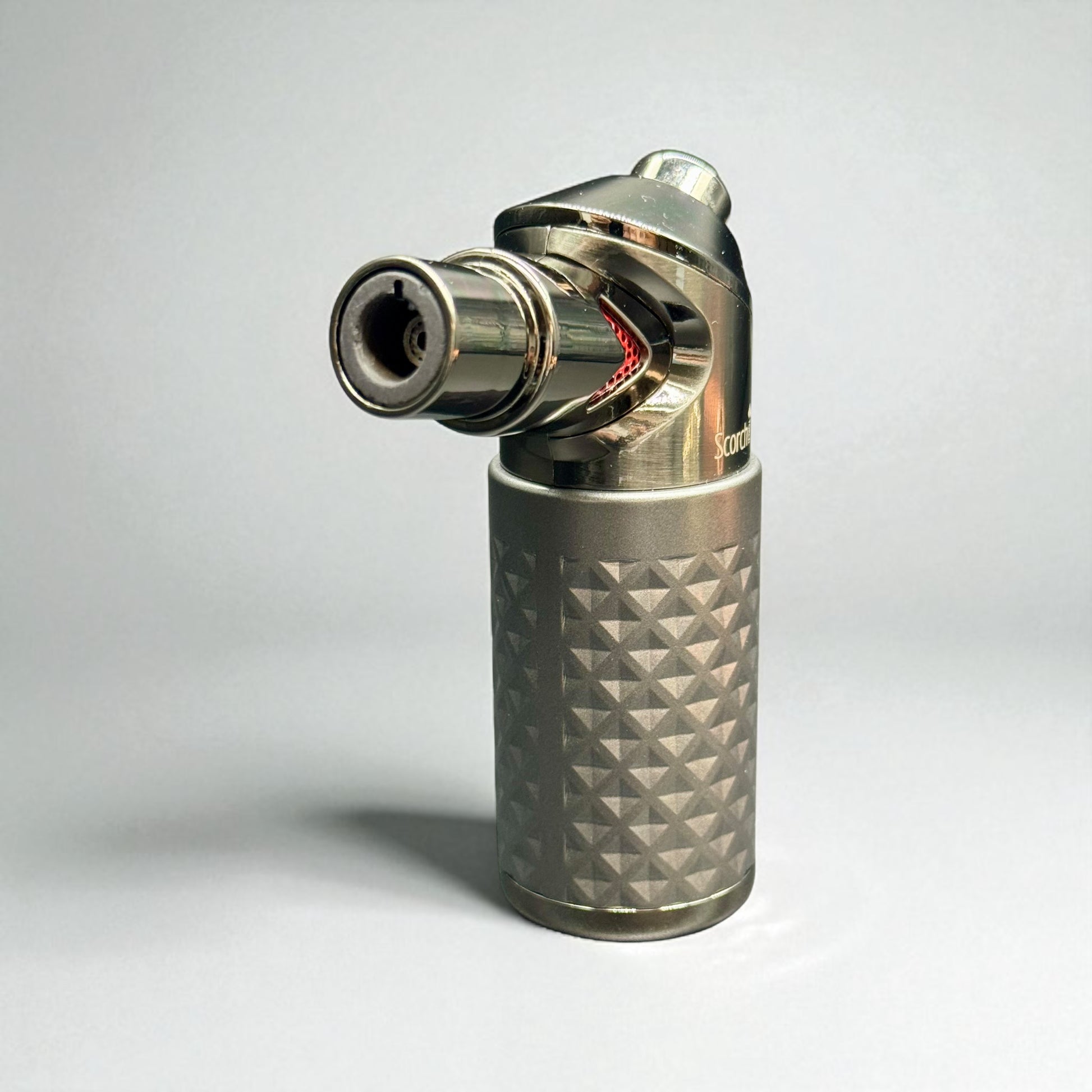 Metallic lighter with geometric pattern on a white background