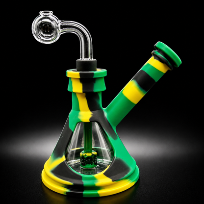 Glass smoking device with green, yellow, and black striped silicone cover on a black background