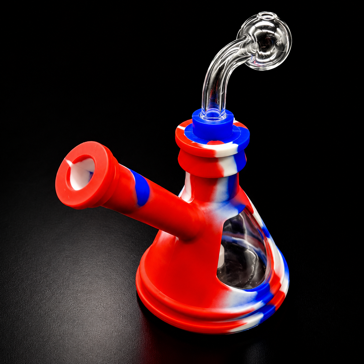 Red, white, and blue glass smoking device on a black background