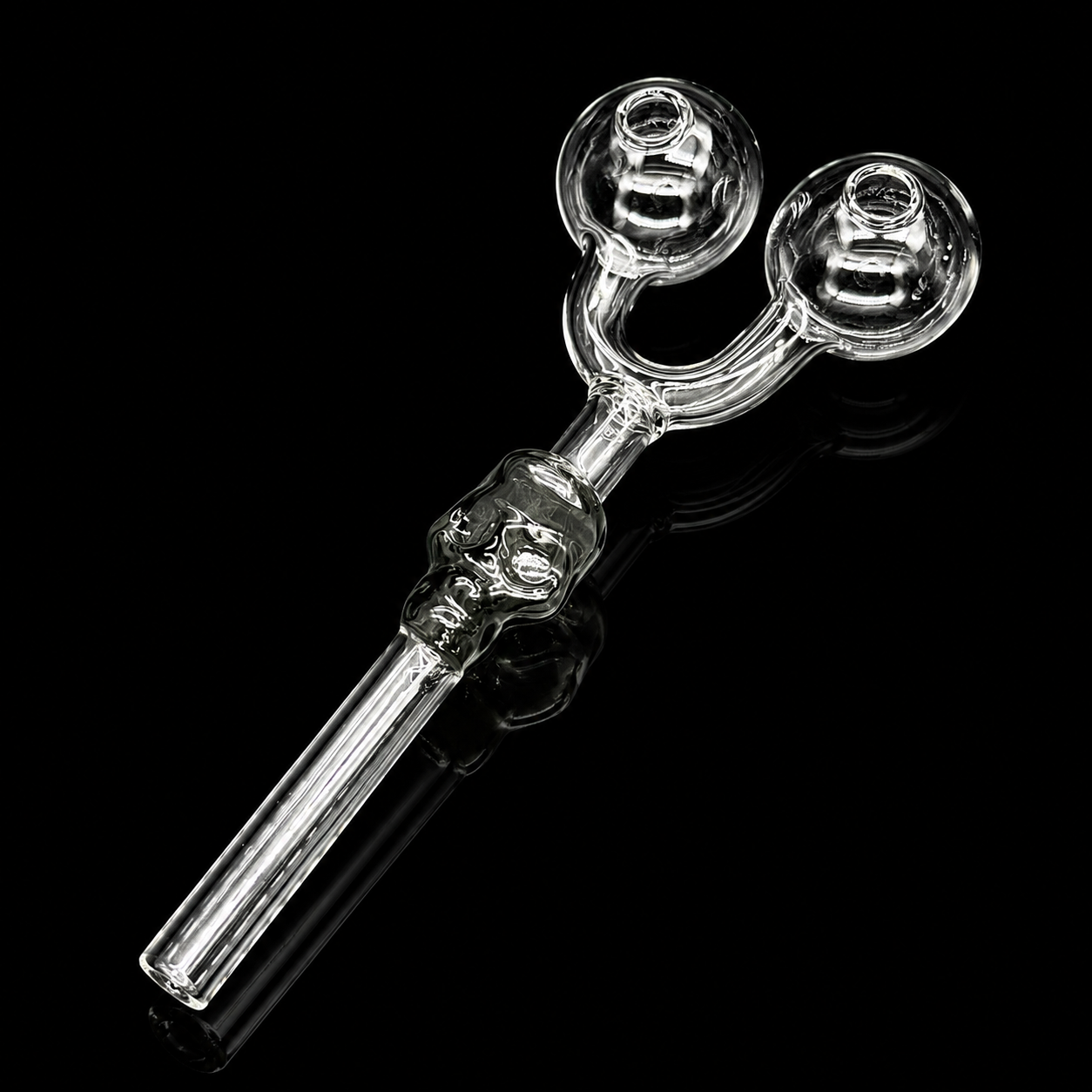 Clear glass smoking accessory with two chambers on a black background
