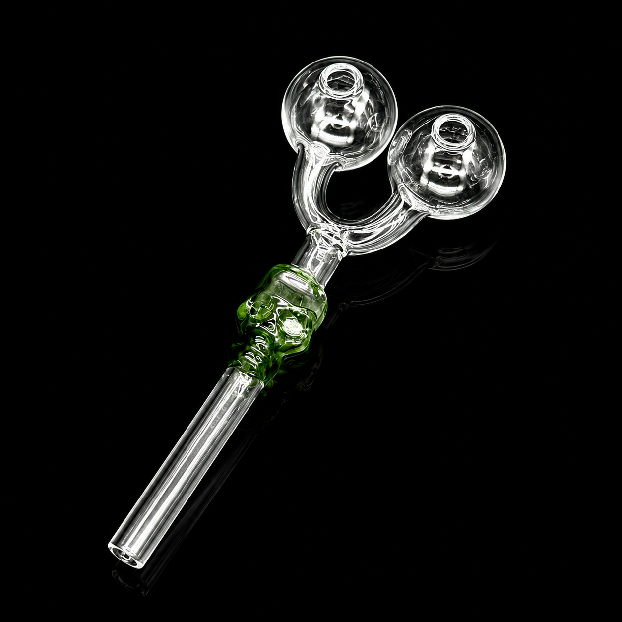 Glass smoking accessory with green base on a black background